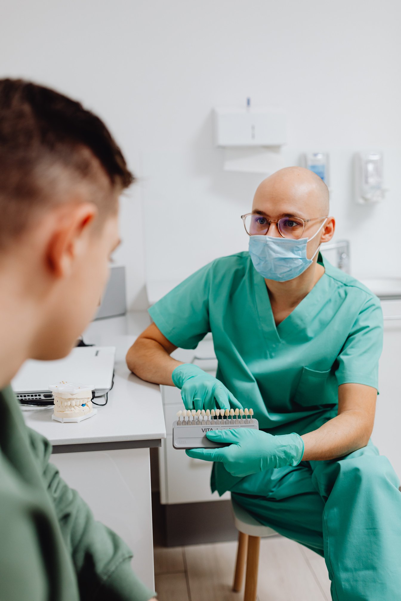  A Dentist Holding a Dental Shade Guide